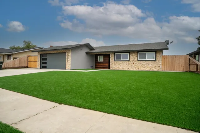 a front view of house with yard and green space