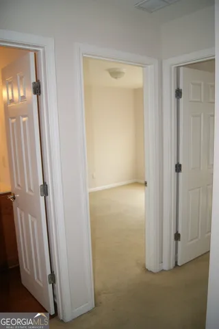 an entryway with wooden floor and a door