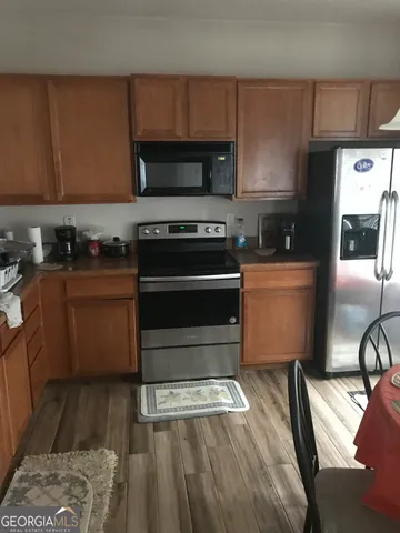 a kitchen with a stove a microwave and a cabinets