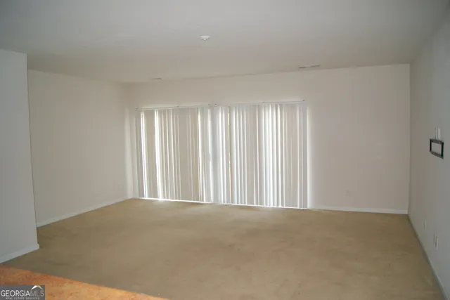 a view of a room with windows and a ceiling fan
