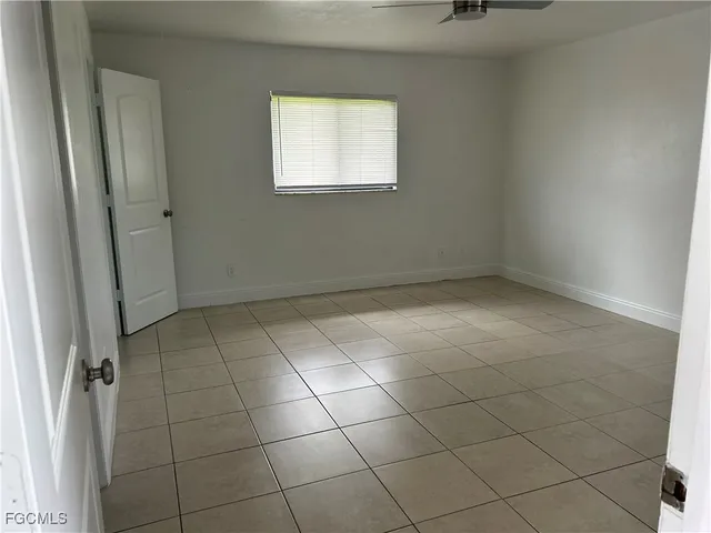 a bathroom with a granite countertop sink a toilet and mirror