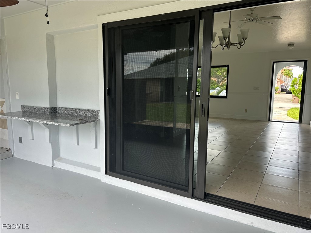729 Southwest 46th Street Cape Coral, FL 33914 - Photo 19 of 20 a view of a hallway with wooden floor and a living room