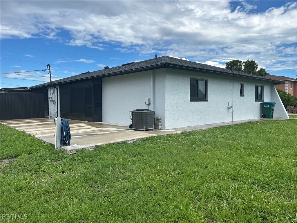729 Southwest 46th Street Cape Coral, FL 33914 - Photo 3 of 20 a house with a yard