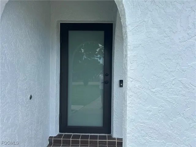 a bathroom with a glass shower door