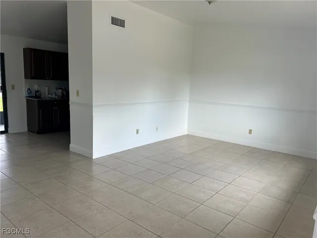 a view of a refrigerator and cabinets