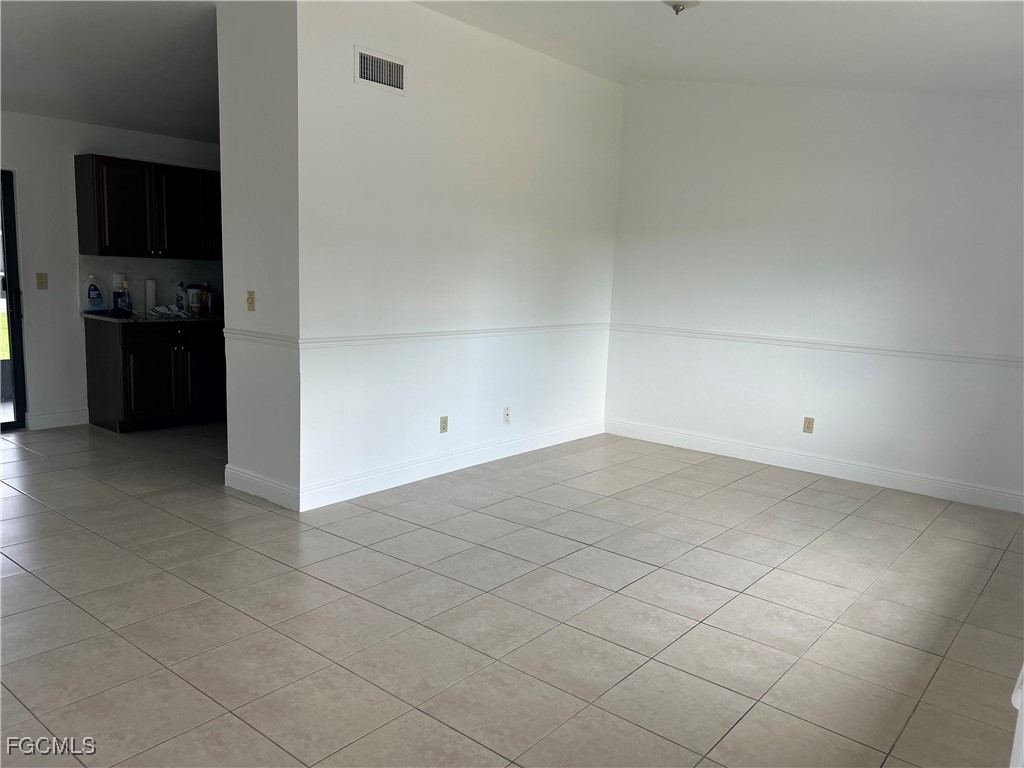 729 Southwest 46th Street Cape Coral, FL 33914 - Photo 6 of 20 a view of a refrigerator and cabinets