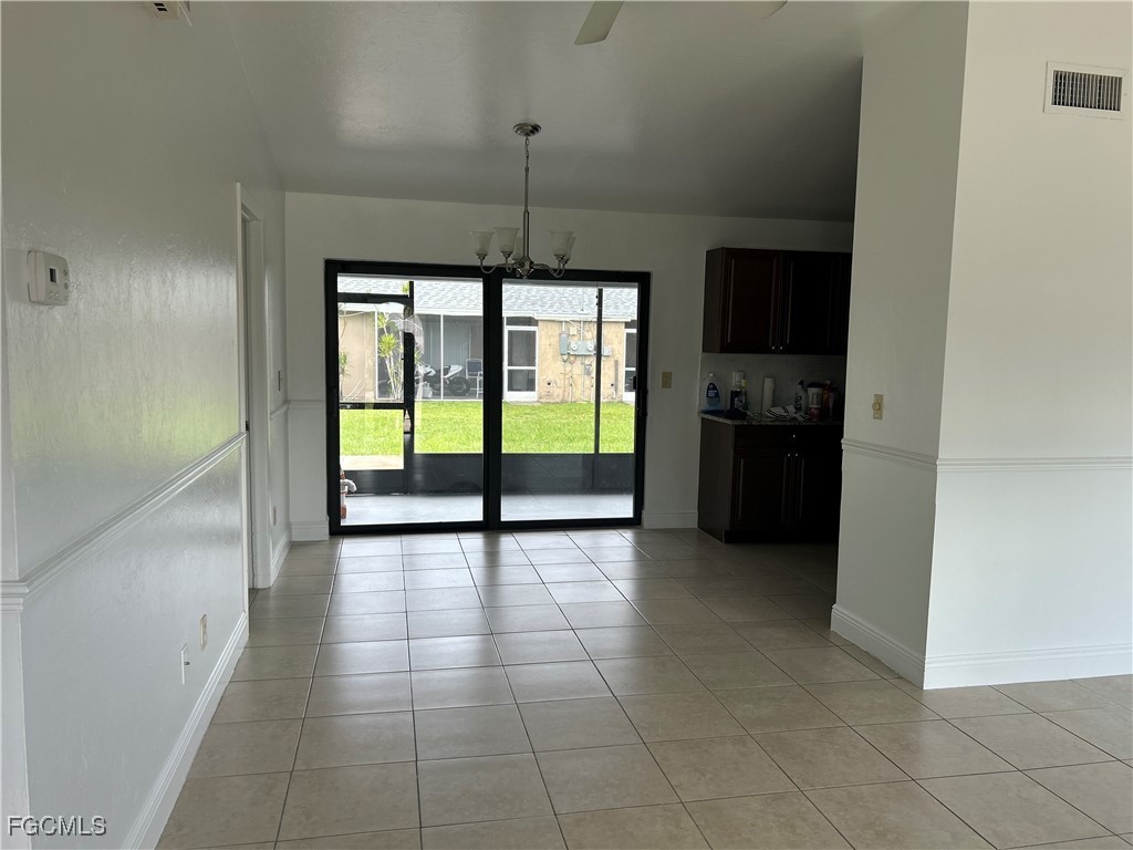 729 Southwest 46th Street Cape Coral, FL 33914 - Photo 7 of 20 a view of a kitchen with microwave and stove