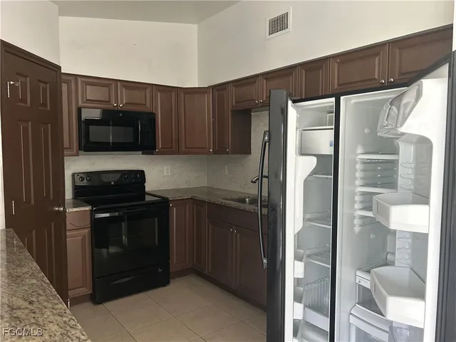 a kitchen with a refrigerator and a sink