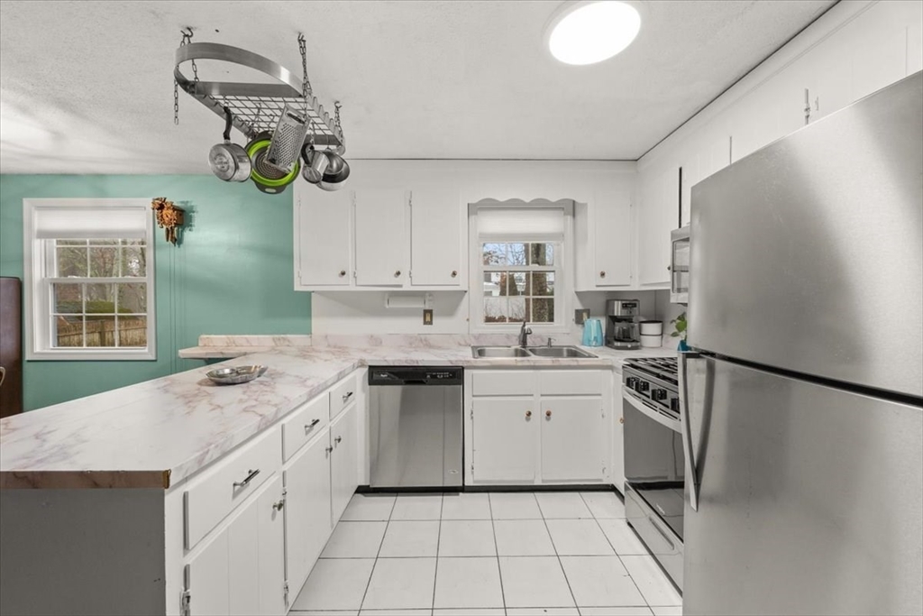281 Megan Road Barnstable, MA 02601 - Photo 11 of 36 a kitchen with a sink a refrigerator and window
