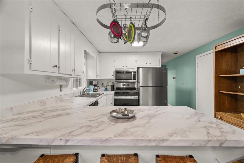 281 Megan Road Barnstable, MA 02601 - Photo 12 of 36 a kitchen with refrigerator and cabinets