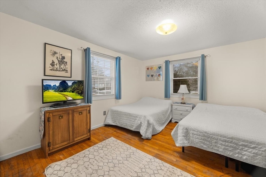 281 Megan Road Barnstable, MA 02601 - Photo 24 of 36 a bedroom with two beds and painting on the wall