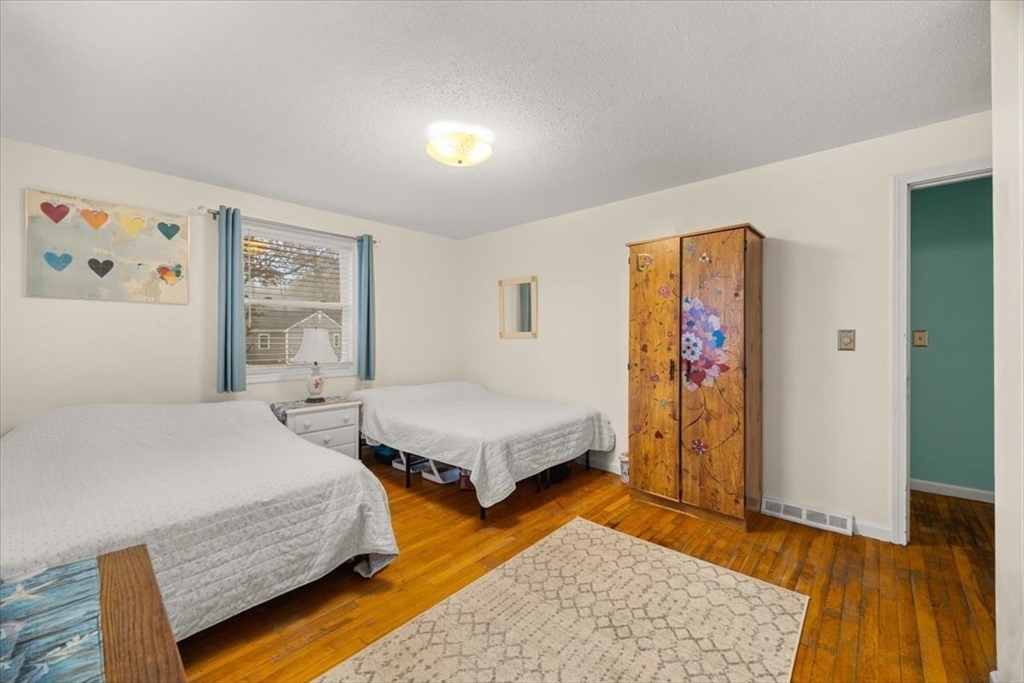 281 Megan Road Barnstable, MA 02601 - Photo 25 of 36 a bedroom with a bed and wooden floor