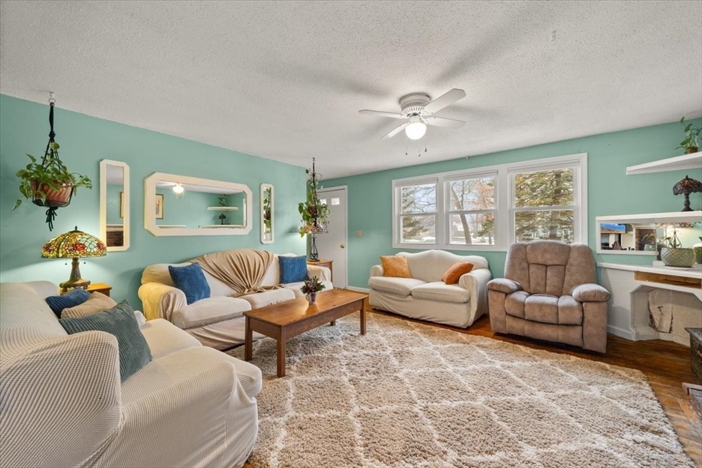 281 Megan Road Barnstable, MA 02601 - Photo 6 of 36 a living room with furniture ceiling fan and a rug