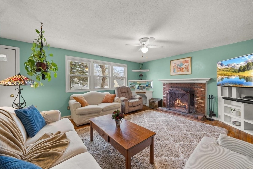 281 Megan Road Barnstable, MA 02601 - Photo 8 of 36 a living room with furniture a fireplace and a flat screen tv