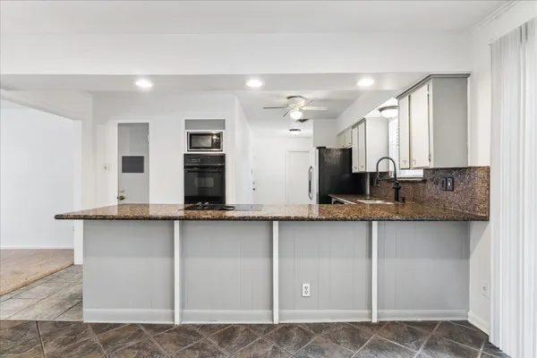 a view of a kitchen with granite countertop cabinets and a sink