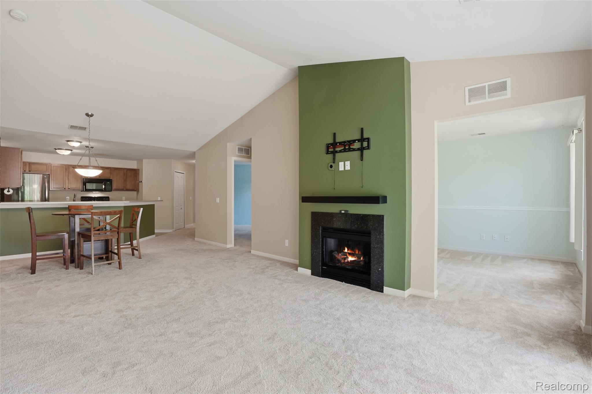 320 North Wixom Road, Unit 30 Wixom, MI 48393 - Photo 7 of 28 Cathedral ceilings in great room w/gas fireplace