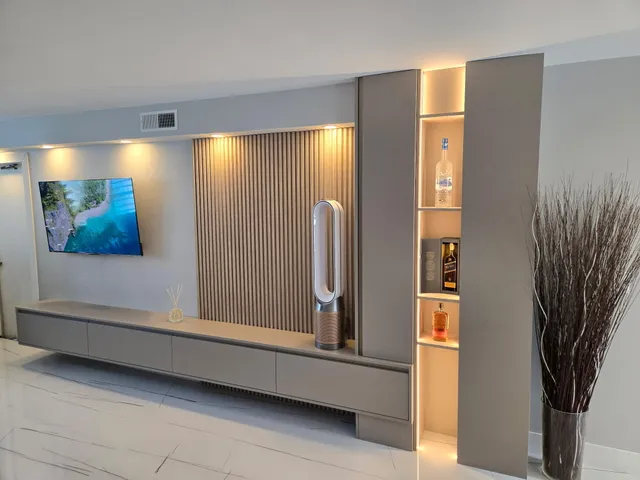 a view of a livingroom with a bench and a bookshelf
