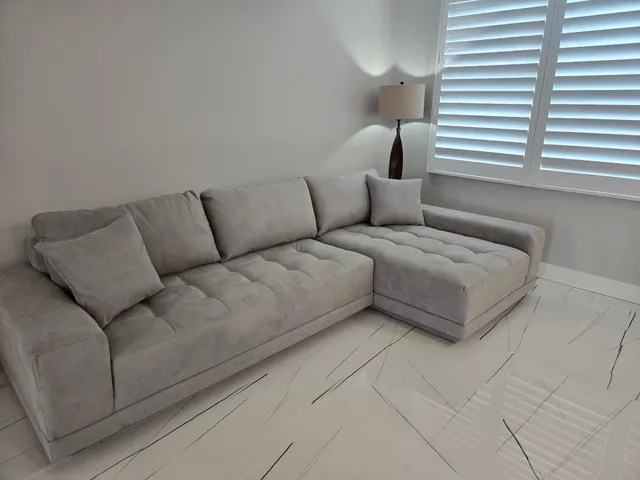 a living room with furniture and a lamp