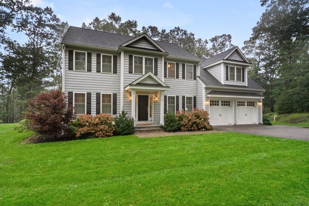 front view of a house next to a yard