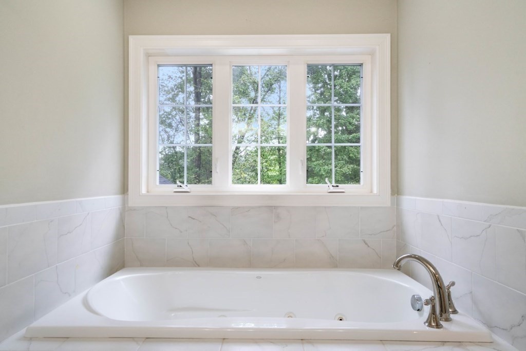 5 Bennett Road Wayland, MA 01778 - Photo 15 of 28 a white bath tub sitting in a bathroom next to a window