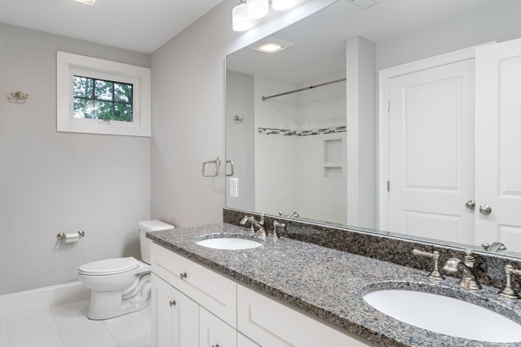 5 Bennett Road Wayland, MA 01778 - Photo 18 of 28 a bathroom with a granite countertop sink a toilet and a mirror