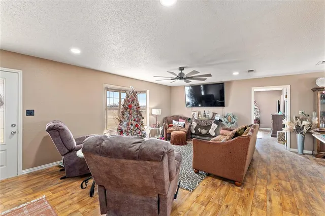 a living room with furniture and a wooden floor