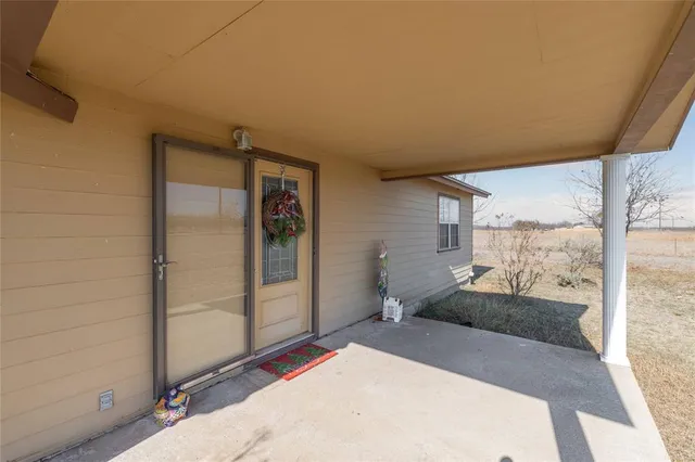 a view of a backyard with lawn chairs and wooden floor