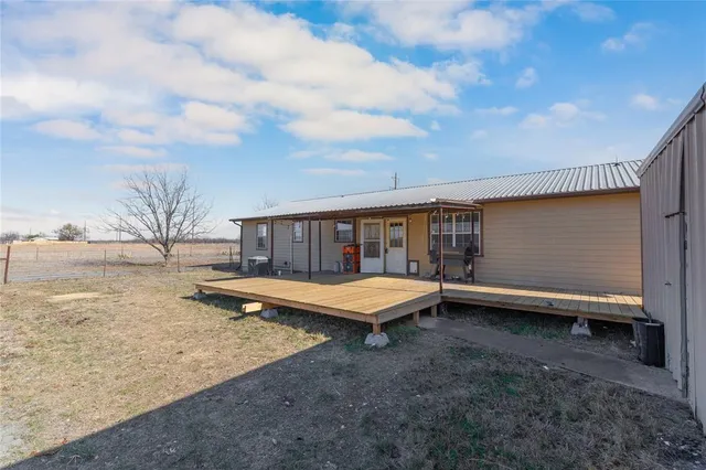 a wooden bench sitting in middle of a backyard