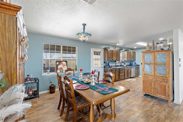 a room with stainless steel appliances kitchen island granite countertop furniture and a kitchen view
