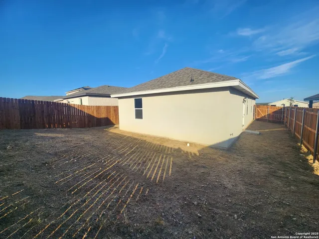 a view of a backyard of the house