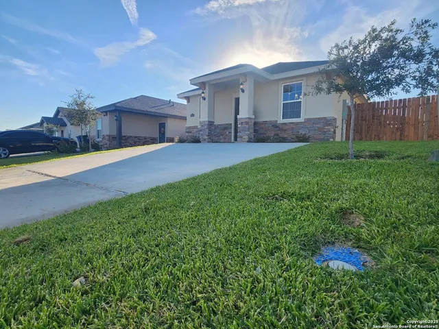 a front view of house with yard and outdoor seating