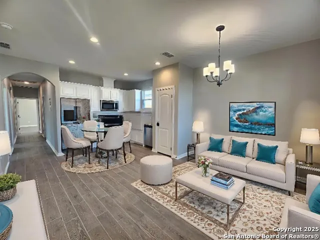 a living room with lots of furniture and a chandelier