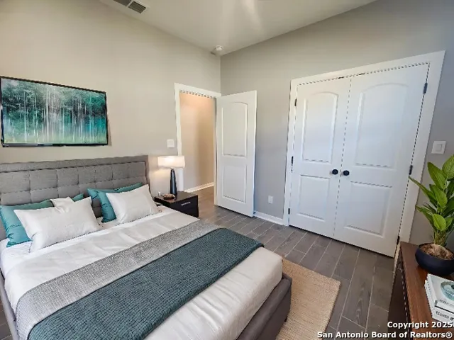 a bedroom with a bed and a painting on the wall