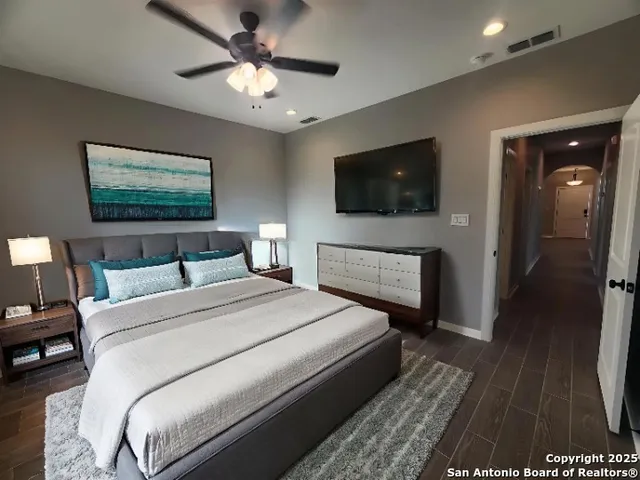 a bedroom with a bed and a flat screen tv