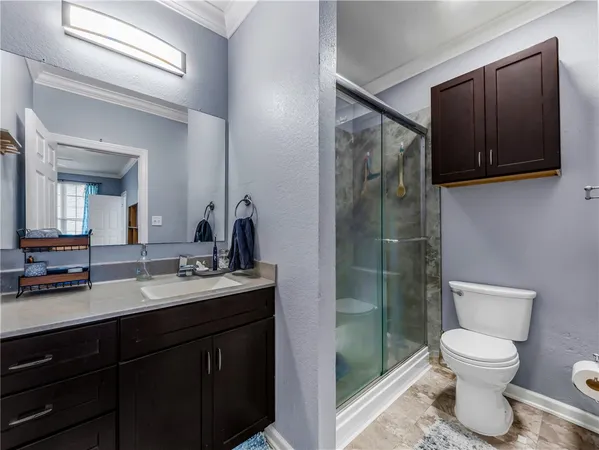 a bathroom with a toilet sink double vanity and mirror