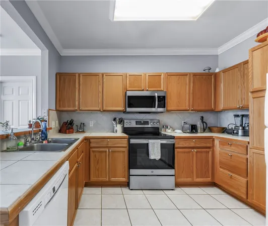 a kitchen with stainless steel appliances granite countertop a sink and cabinets
