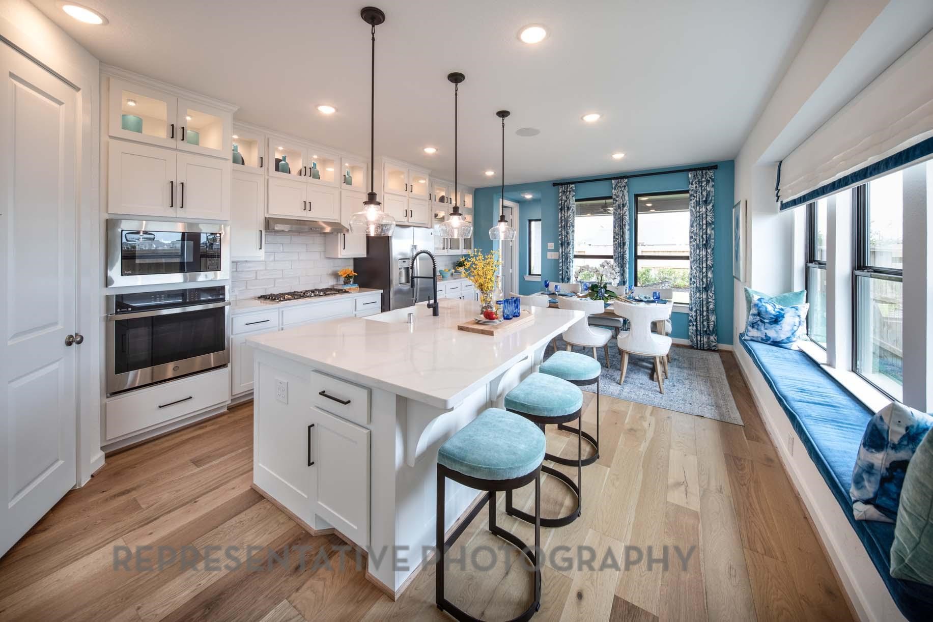 2426 Guava Hls Lane Manvel, TX 77578 - Photo 2 of 48 a open kitchen with stainless steel appliances granite countertop a lot of counter space and a wooden floors