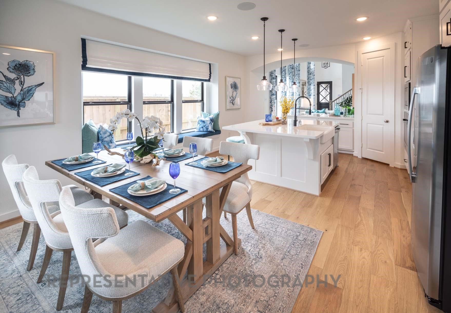 2426 Guava Hls Lane Manvel, TX 77578 - Photo 21 of 48 a dining room with furniture a large window and a wooden floor