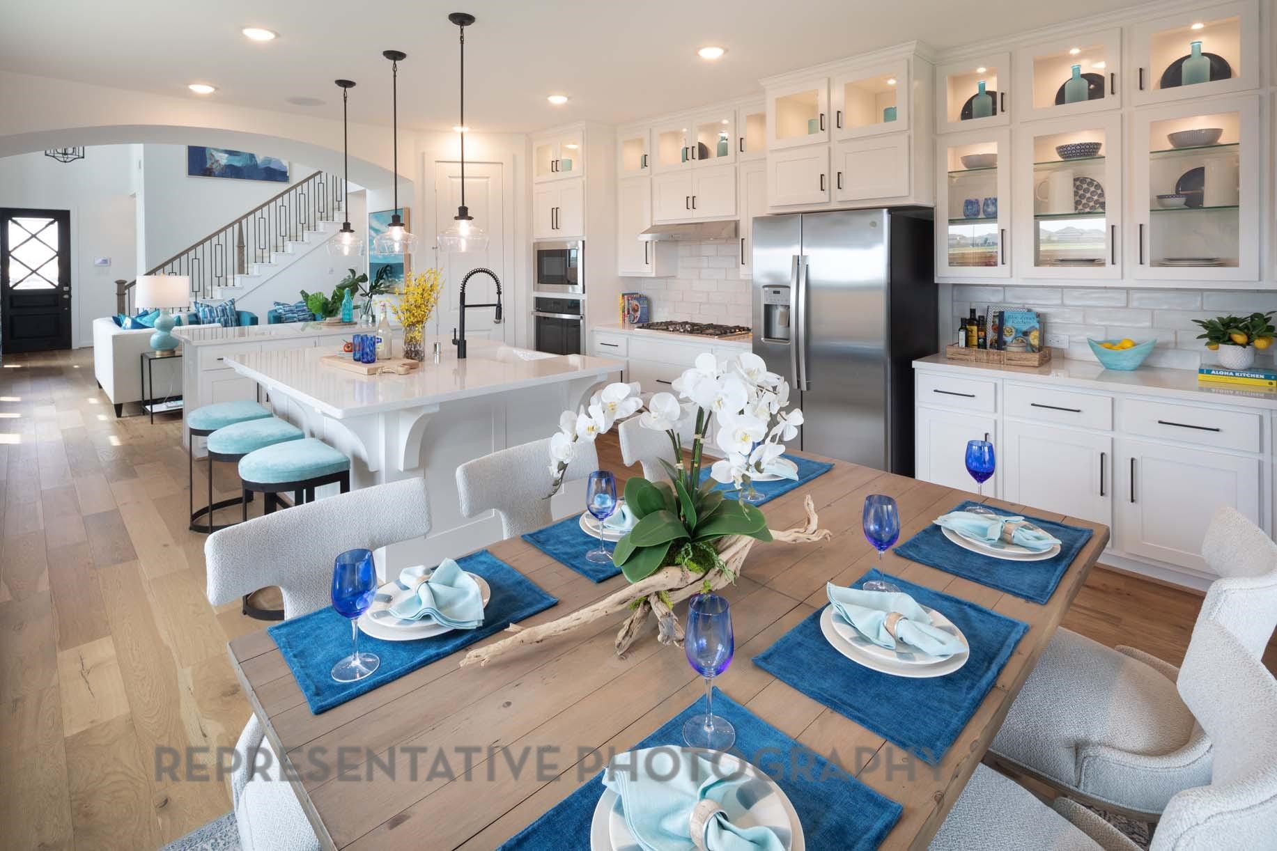 2426 Guava Hls Lane Manvel, TX 77578 - Photo 22 of 48 a kitchen with stainless steel appliances kitchen island granite countertop a dining table and chairs in it