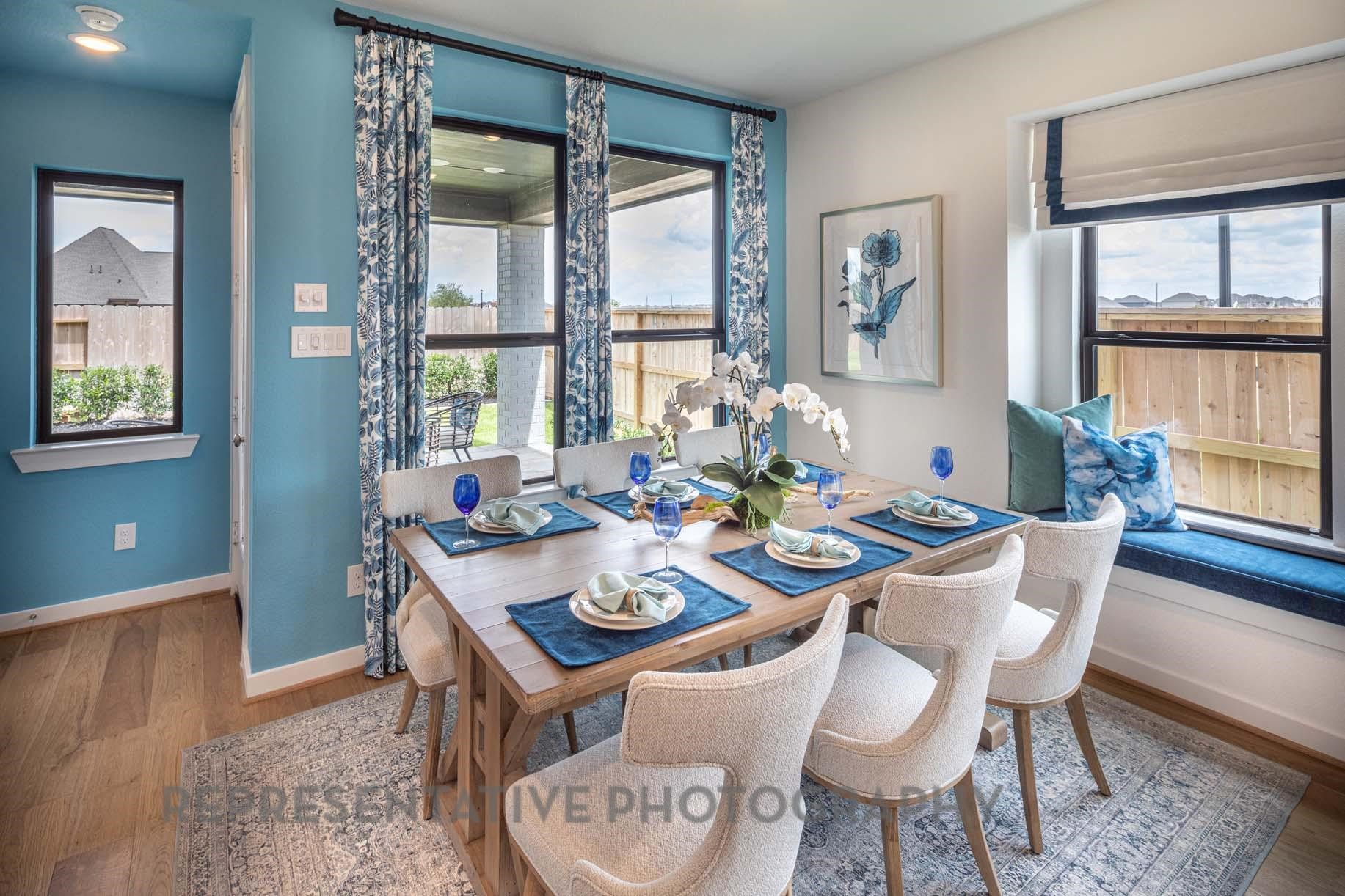2426 Guava Hls Lane Manvel, TX 77578 - Photo 23 of 48 a view of a dining room with furniture large windows and wooden floor