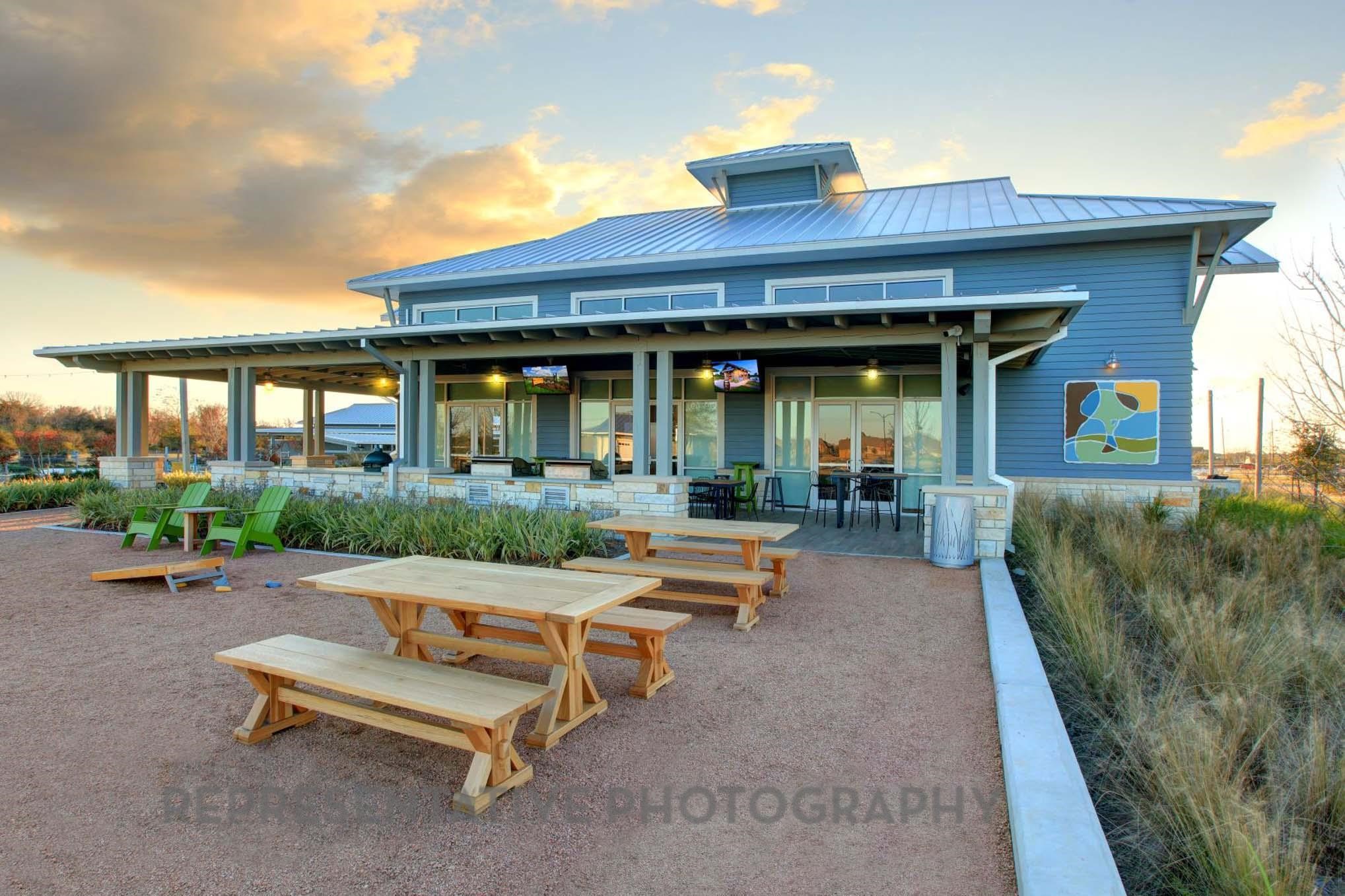 2426 Guava Hls Lane Manvel, TX 77578 - Photo 35 of 48 a view of a patio with table and chairs under an umbrella
