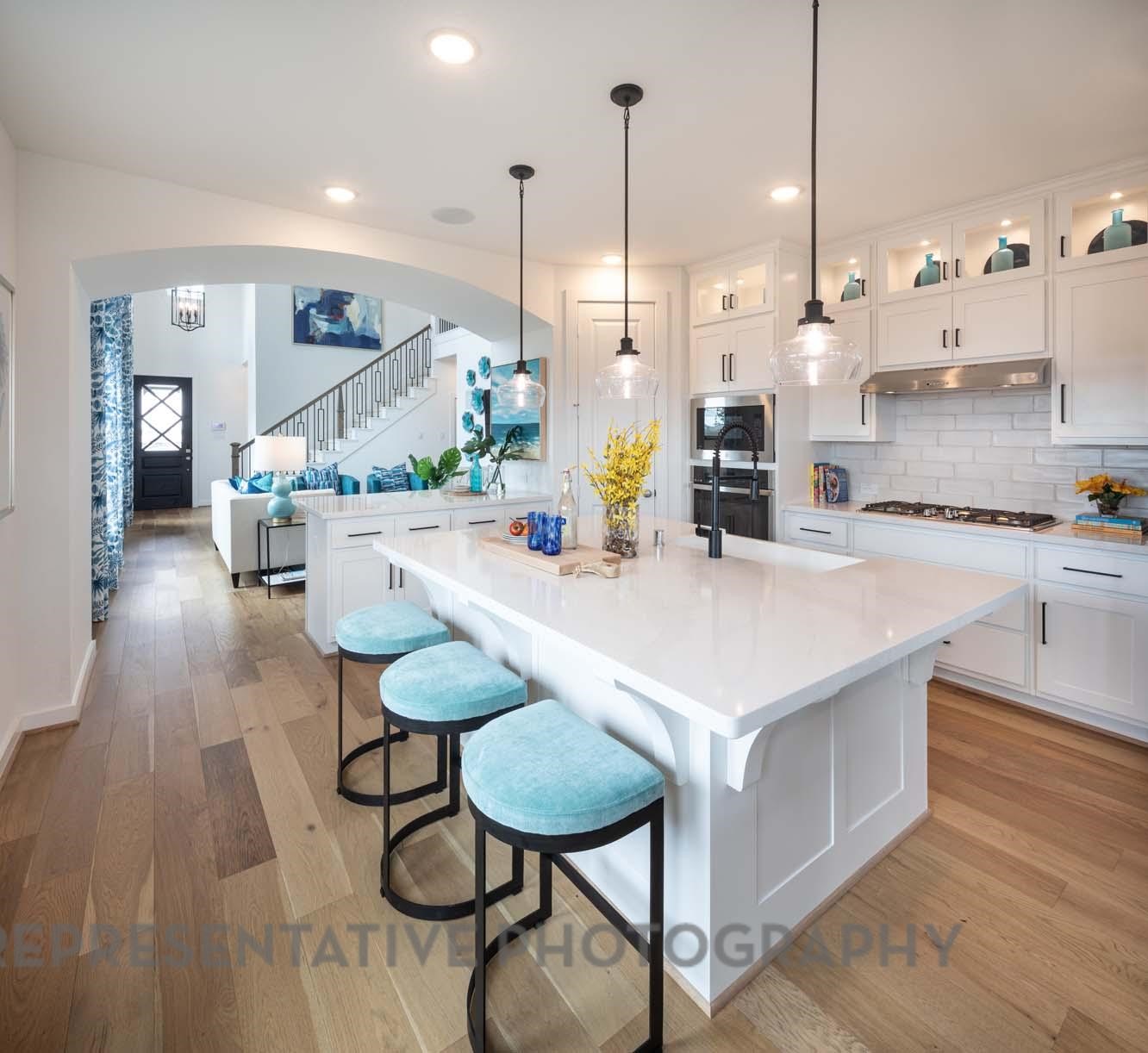 2426 Guava Hls Lane Manvel, TX 77578 - Photo 4 of 48 a kitchen with a table chairs refrigerator and stove