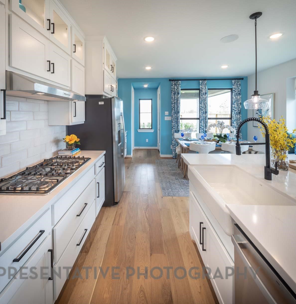 2426 Guava Hls Lane Manvel, TX 77578 - Photo 6 of 48 a kitchen with sink stove and refrigerator