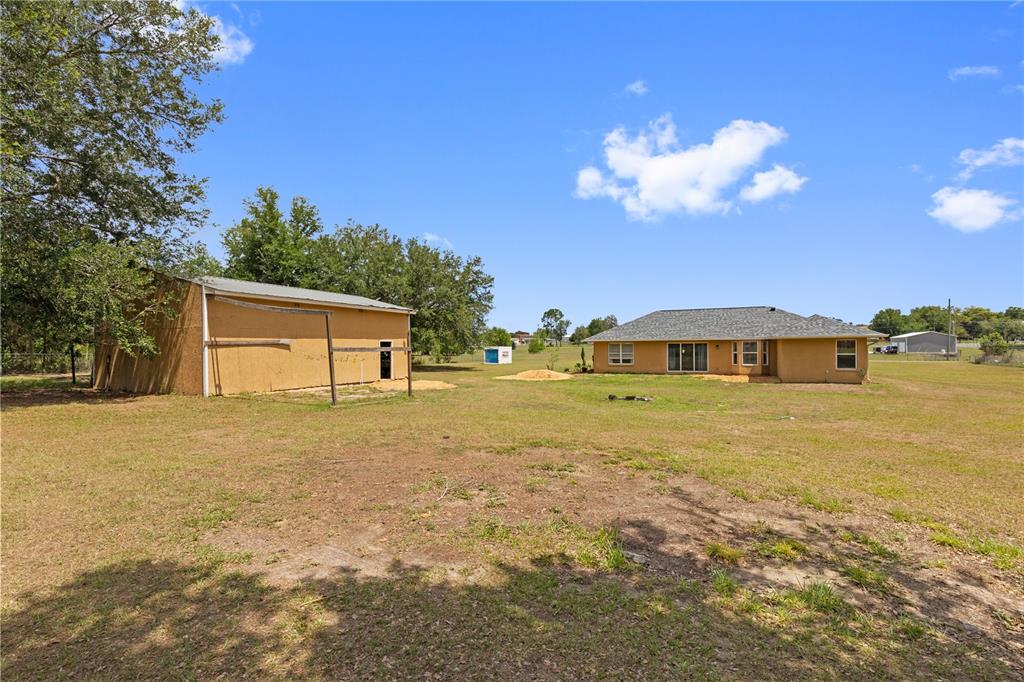 9917 Nelson Road Dade City, FL 33525 - Photo 36 of 40 a front view of house with yard and lake view