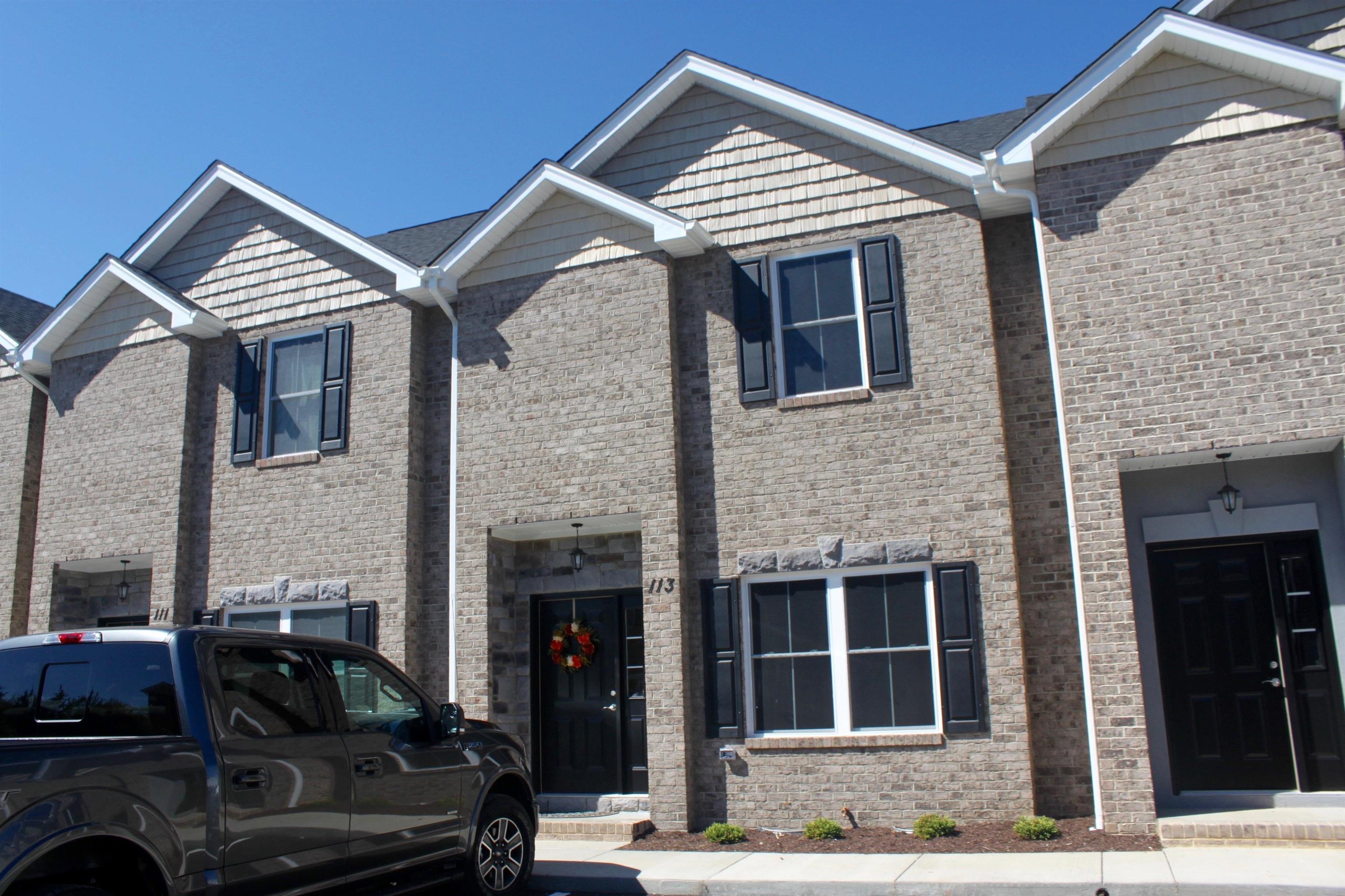 a front view of a house with parking space