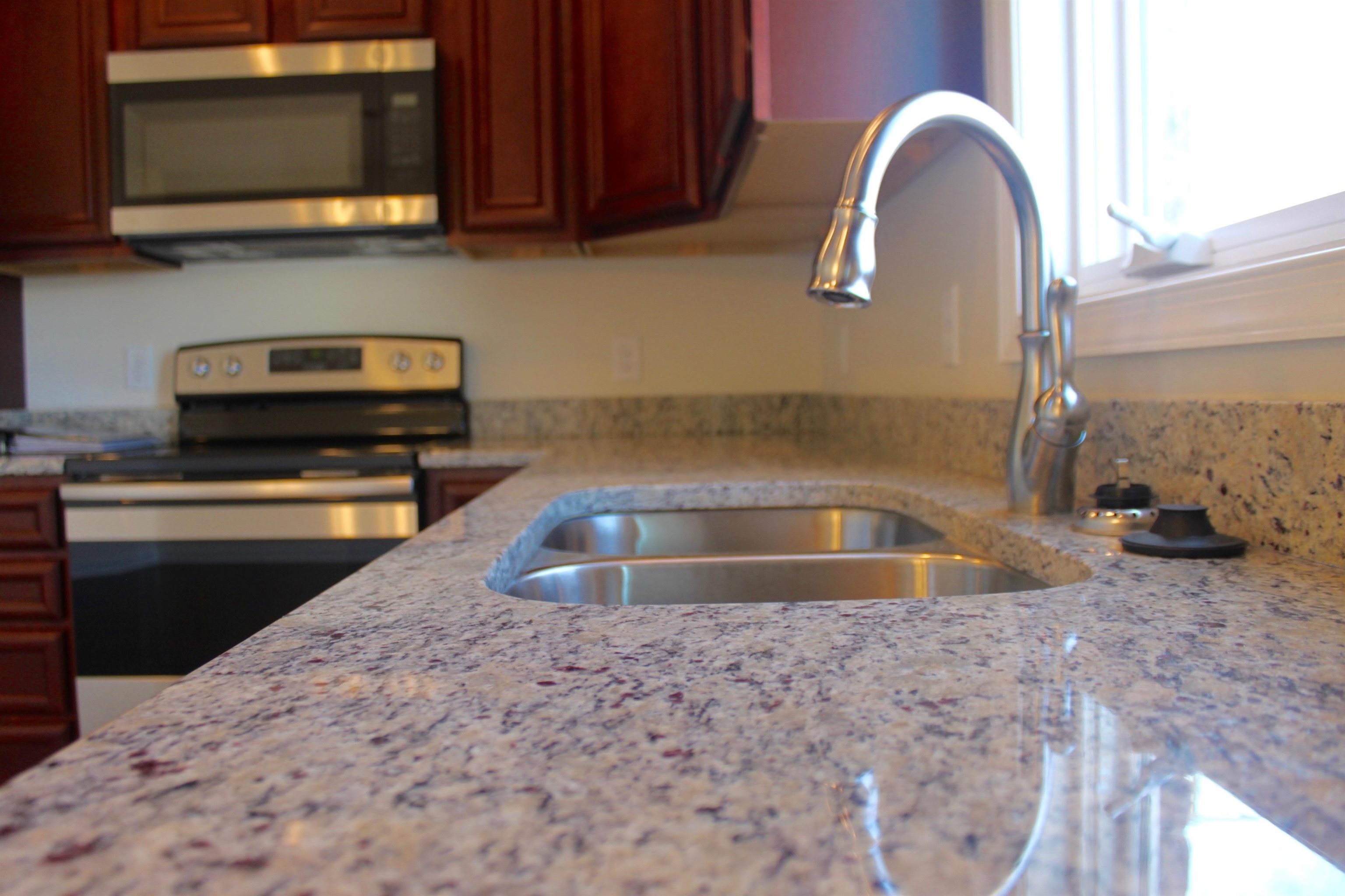 113 Cedar Point Lane Harrisonburg, VA 22802 - Photo 3 of 25 a kitchen with a sink a microwave and cabinets