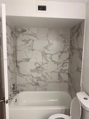 a bathroom with a bathtub and a toilet