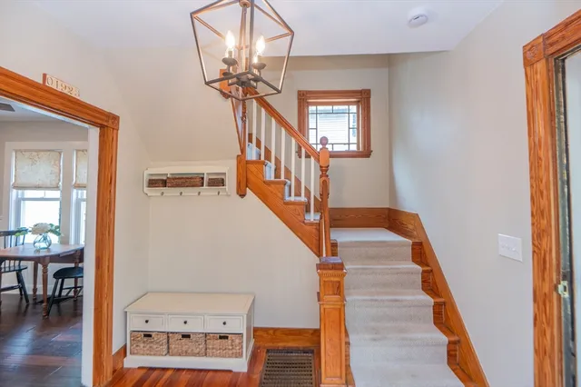 a view of entryway and hall with wooden floor