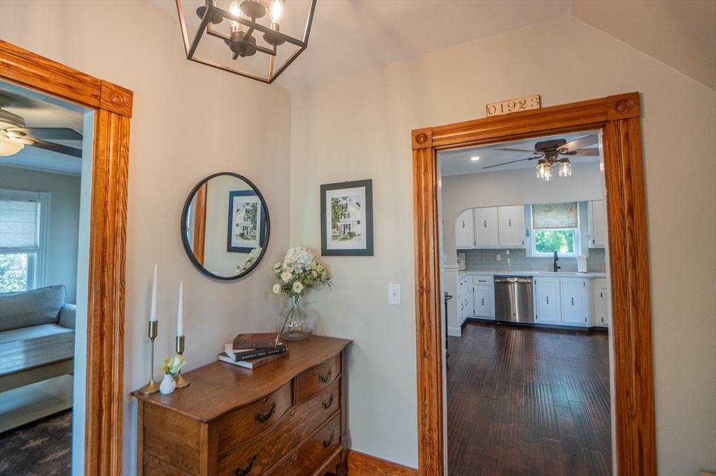 5 Florence Street Danvers, MA 01923 - Photo 12 of 41 a view of a hallway with wooden floor and a living room