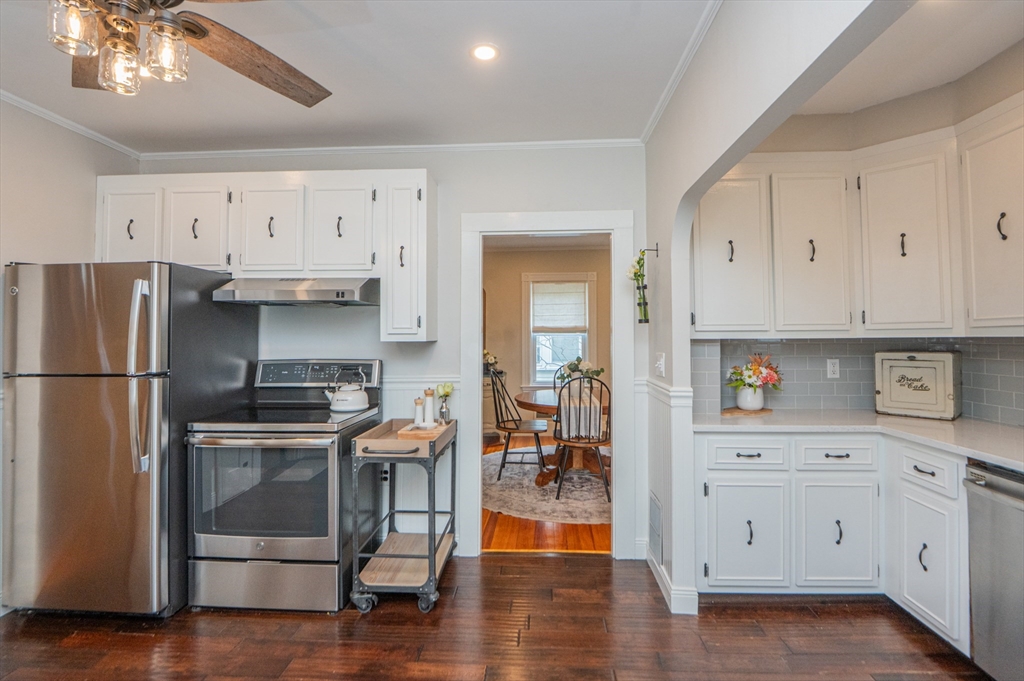 5 Florence Street Danvers, MA 01923 - Photo 15 of 41 a kitchen with white cabinets and stainless steel appliances